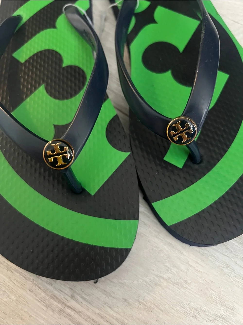 Tory Burch Black Flip Flops with Gold Logo Detail
